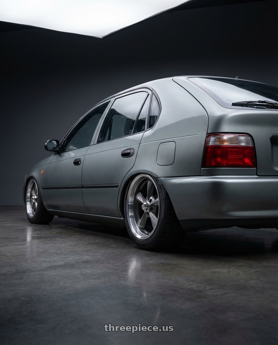 1998 Toyota corolla   with BG Rod Works Old School 5x114.3 15x8+0 Gun Metal Machined Lip wheels rear three quarter view meaty tires