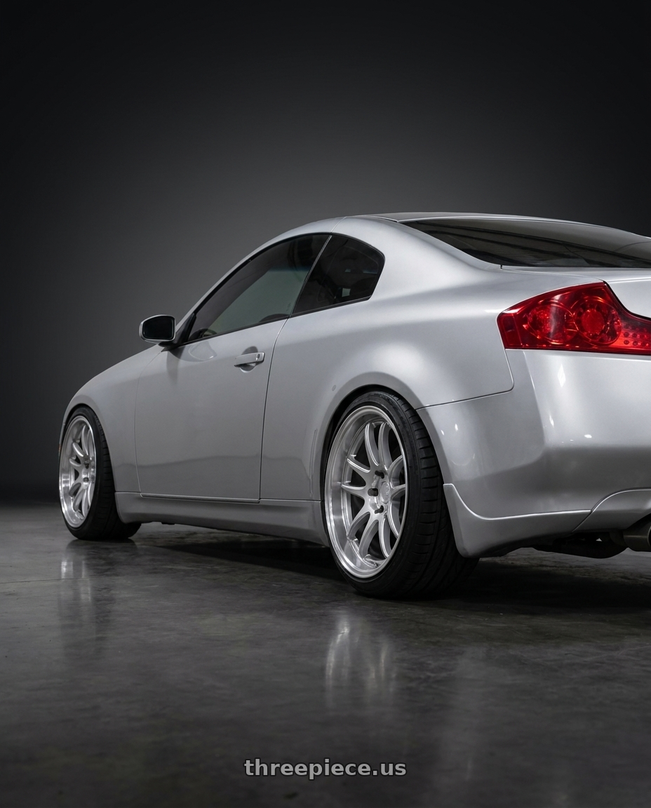 2005 infiniti g35 coupe, silver with Aodhan DS02 5x114.3 18x9.5+15 Silver w/Machined Face wheels rear three quarter view slight stretch tires