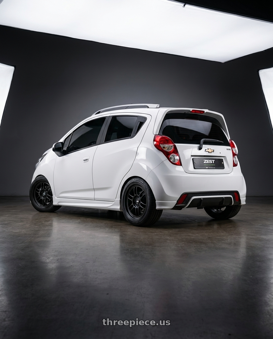 2015 Chevy Spark LS Lemonade with Enkei RPF1 4x100 16x8+38 Black wheels rear three quarter view square tires