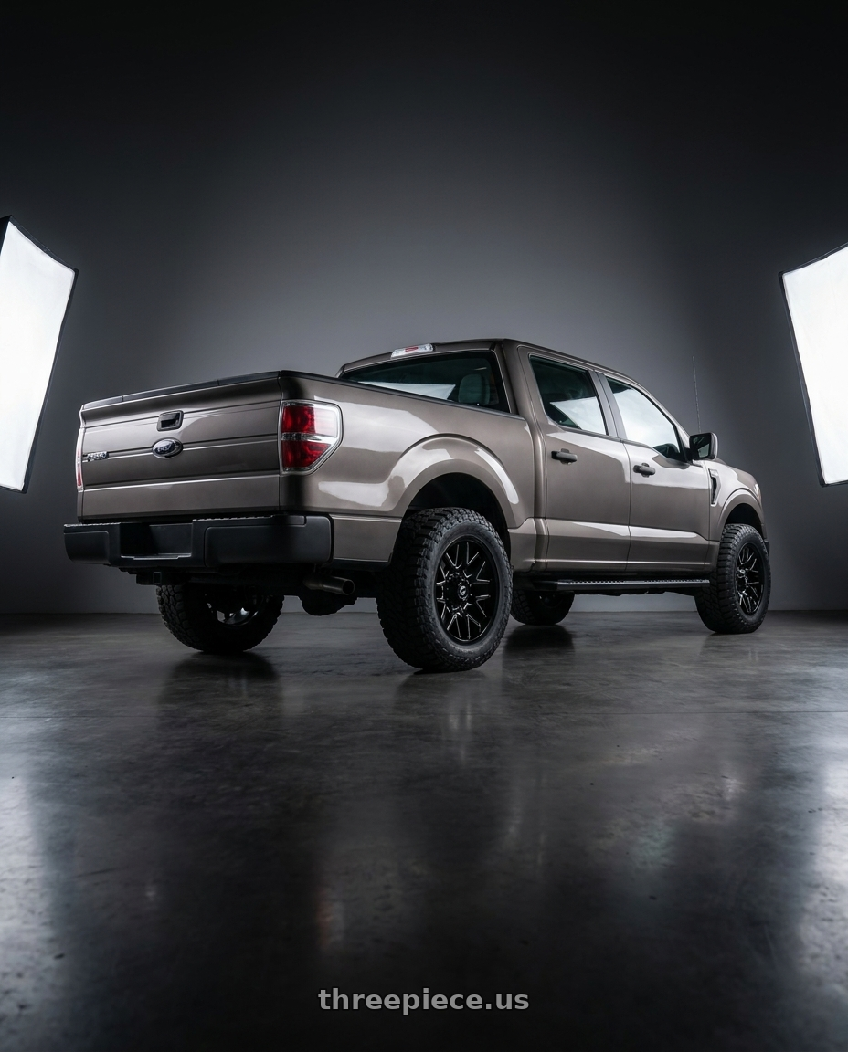 2013 Ford F-150 with Gear Off Road 768BM 6X135/6x139.7 20x9 +0 Gloss Black Milled wheels rear three quarter view meaty tires