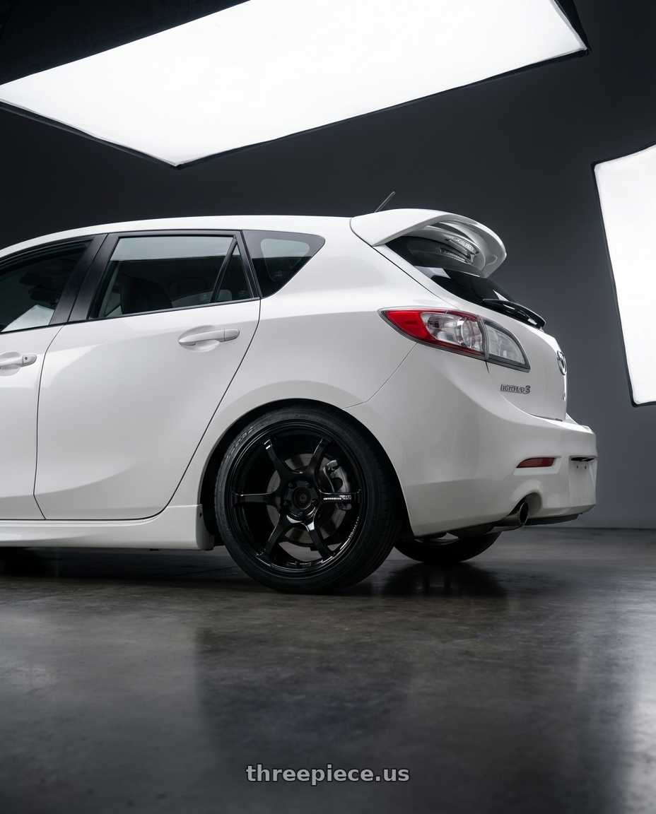 2012 Mazda Mazdaspeed3 with Advan RGIII 5x114.3 18x10.5+15 Gloss Black wheels rear three quarter view square tires
