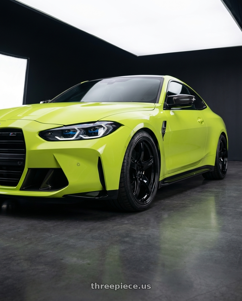 2024 BMW M4 G82 with Gram Lights 57CR 5x112 19x10.5+35 Glossy Black wheels front three quarter view lowered stance