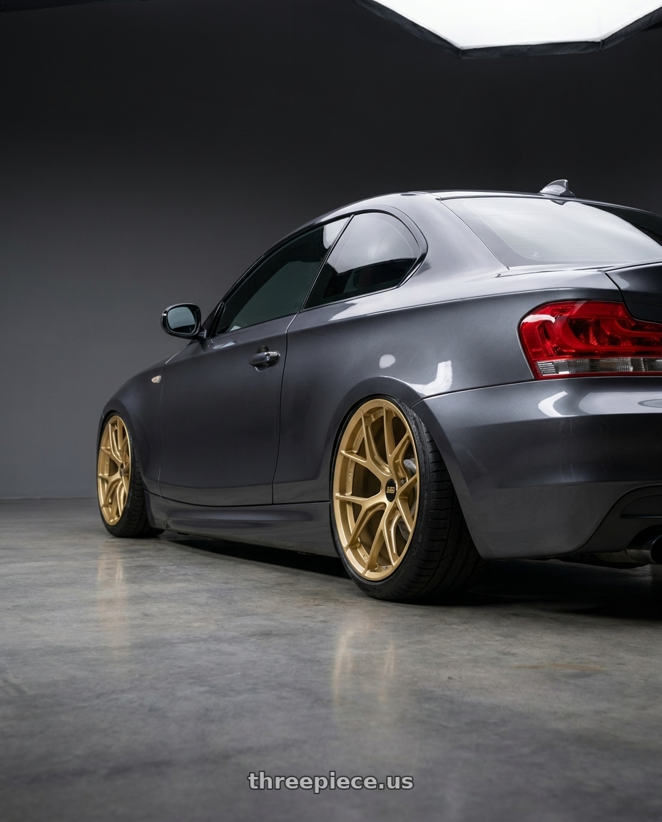 2012 BMW 1 Series E82 with BBS FI-R 5x120 19x10.5+35 Gold wheels rear three quarter view slight stretch tires