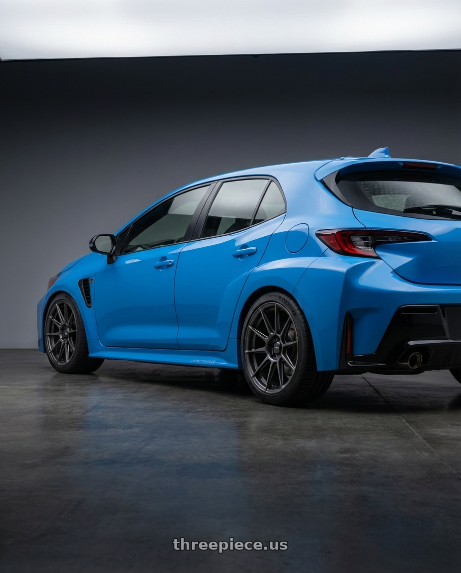 2024 Toyota GR Corolla with Konig Ampliform 5x114.3 18x8.5+45 Dark Metallic Graphite wheels rear three quarter view square tires