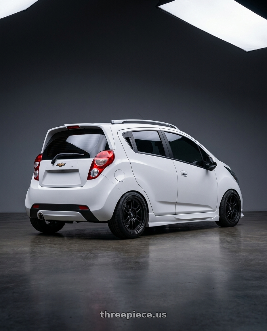 2015 Chevy Spark LS with Enkei RPF1 4x100 15x7+35 Black wheels rear three quarter view slight stretch tires