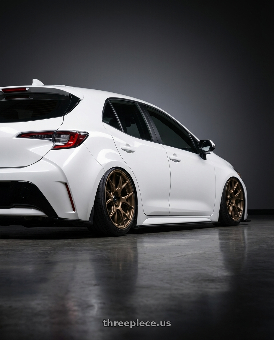 2023 Toyota Corolla Hatchback with Konig Ampliform 5x114.3 18x8.5+45 Gloss Bronze wheels rear three quarter view slight stretch tires