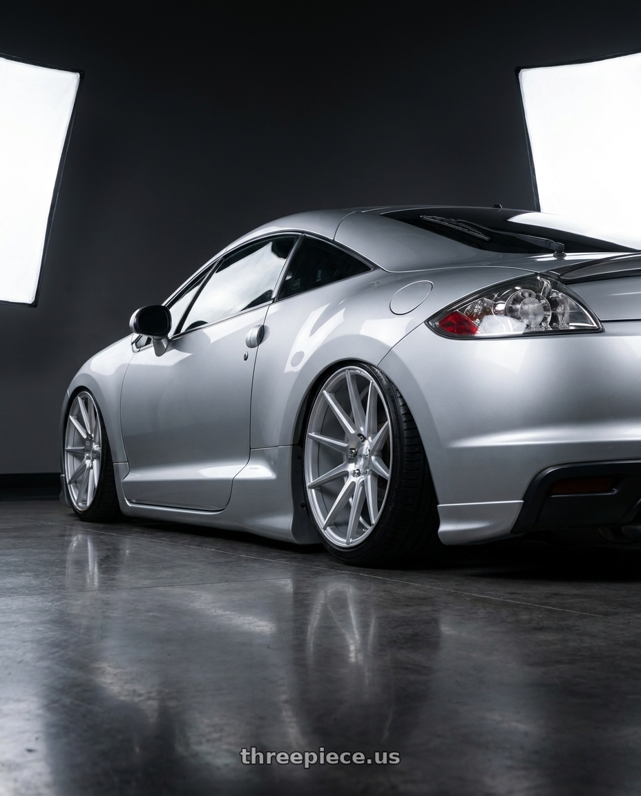 2010 Mitsubishi Eclipse with Niche 1PC M112 SURGE 5X114.3 19X8.5 +35 GLOSS SILVER MACHINED wheels rear three quarter view slight stretch tires