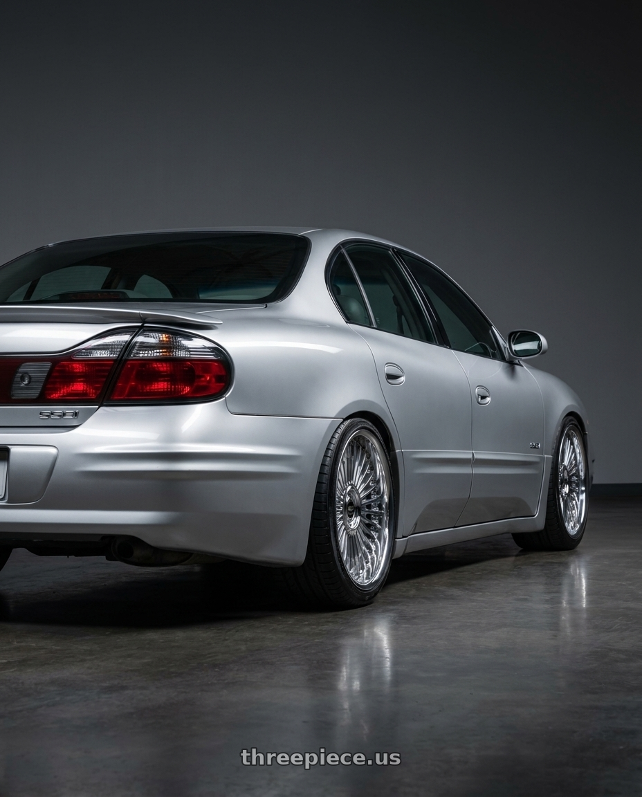 2000 Pontiac Bonneville SSEI Silver with Work Emitz Chrome 5x115 19x8.0 +38 wheels rear three quarter view square tires