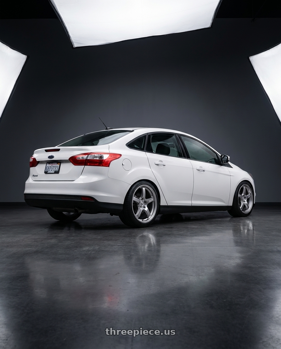 2015 Ford Focus with Gram Lights 57CR 5x114.3 18x9.5+38 Grace Silver wheels rear three quarter view square tires