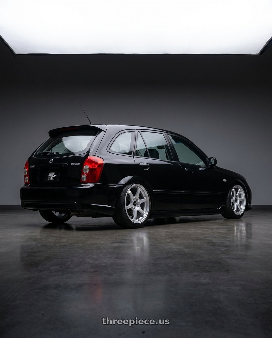 2002 Mazda Protege5 with MST Wheels MT40 5X114.3 16x7.0 +38 Glossy Silver wheels rear three quarter view square tires
