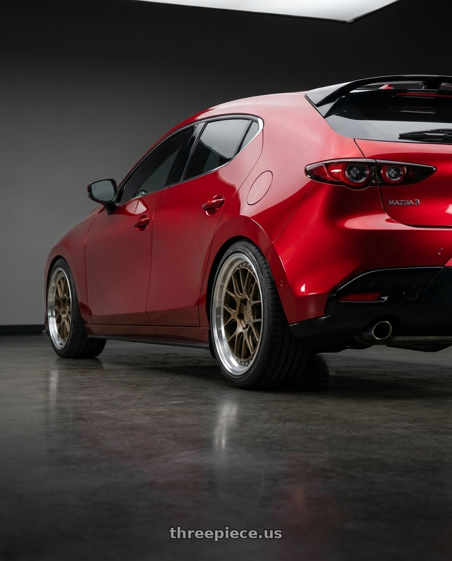 2026 Mazda 3 hatchback with Aodhan DS06 5x114.3 18x8.5+35 Bronze w/Machined Lip wheels rear three quarter view square tires
