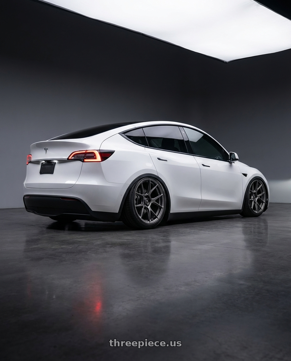 2024 Tesla Model Y with Konig Ampliform 5x114.3 20x11+50 Dark Metallic Graphite wheels rear three quarter view slight stretch tires