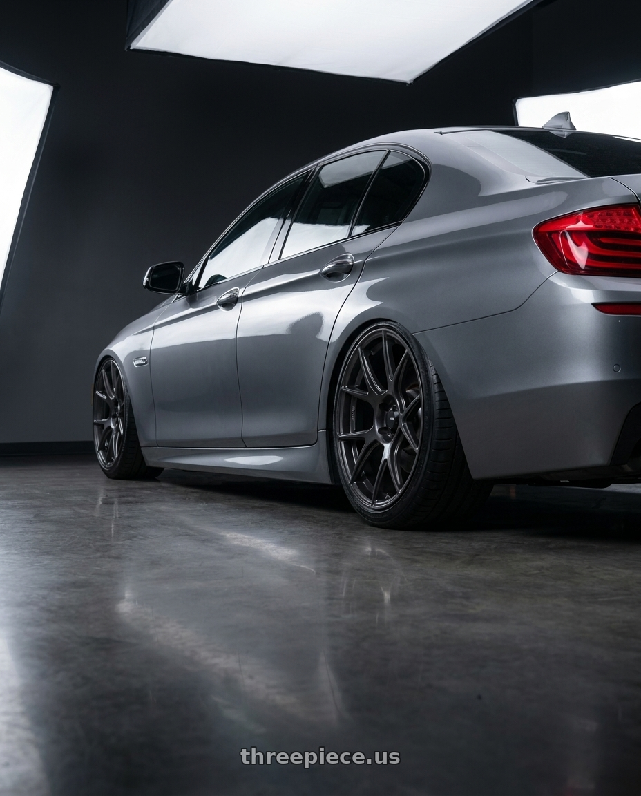 2016 BMW 5 Series F10 with Konig Ampliform 5x120 20x8.5+45 Dark Metallic Graphite wheels rear three quarter view slight stretch tires
