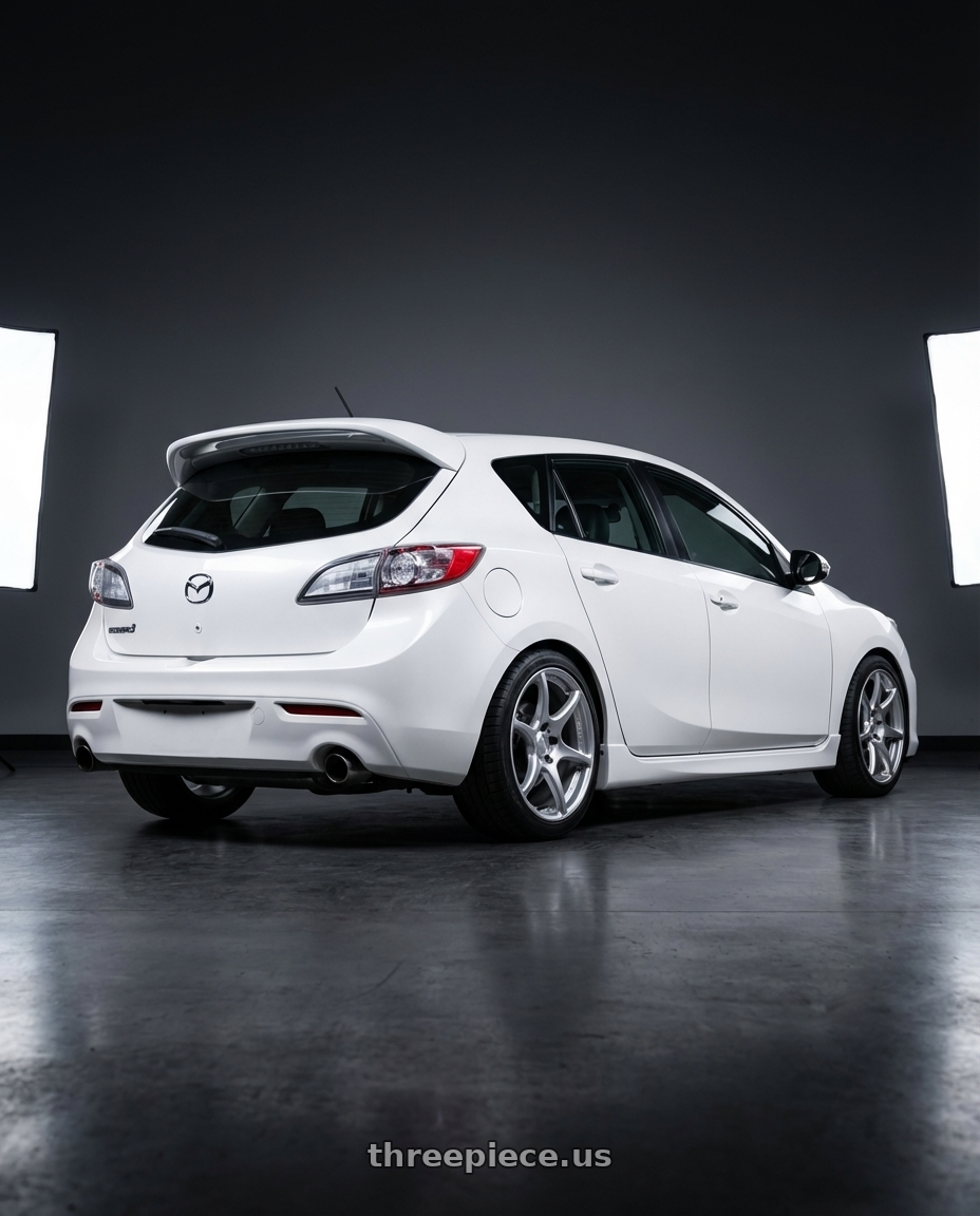 2012 Mazda Mazdaspeed3 with Kansei K11S Tandem 5x114.3 18x8.5 35 Hyper Silver wheels rear three quarter view square tires