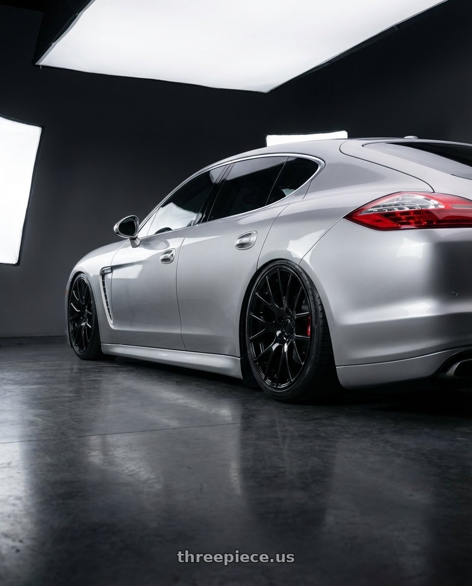 2012 Porsche Panamera  with OEP 161B 5X115 22x10 +18 Gloss Black wheels rear three quarter view slight stretch tires