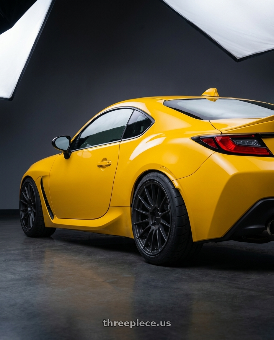 2026 Subaru BRZ STI Sport Yellow Edition with Enkei RS05-RR 5x100 18x8.5+42 Matte Gunmetal wheels rear three quarter view meaty tires