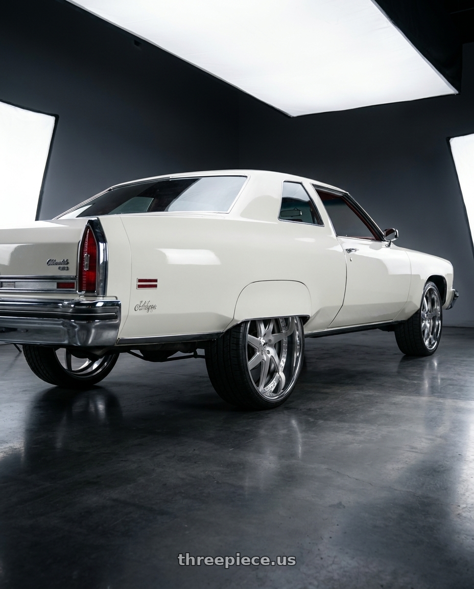 1976 Oldsmobile 98 Regency  with Amani Devine 5X127 26x10 +5 Brush center Chrome lip wheels rear three quarter view square tires