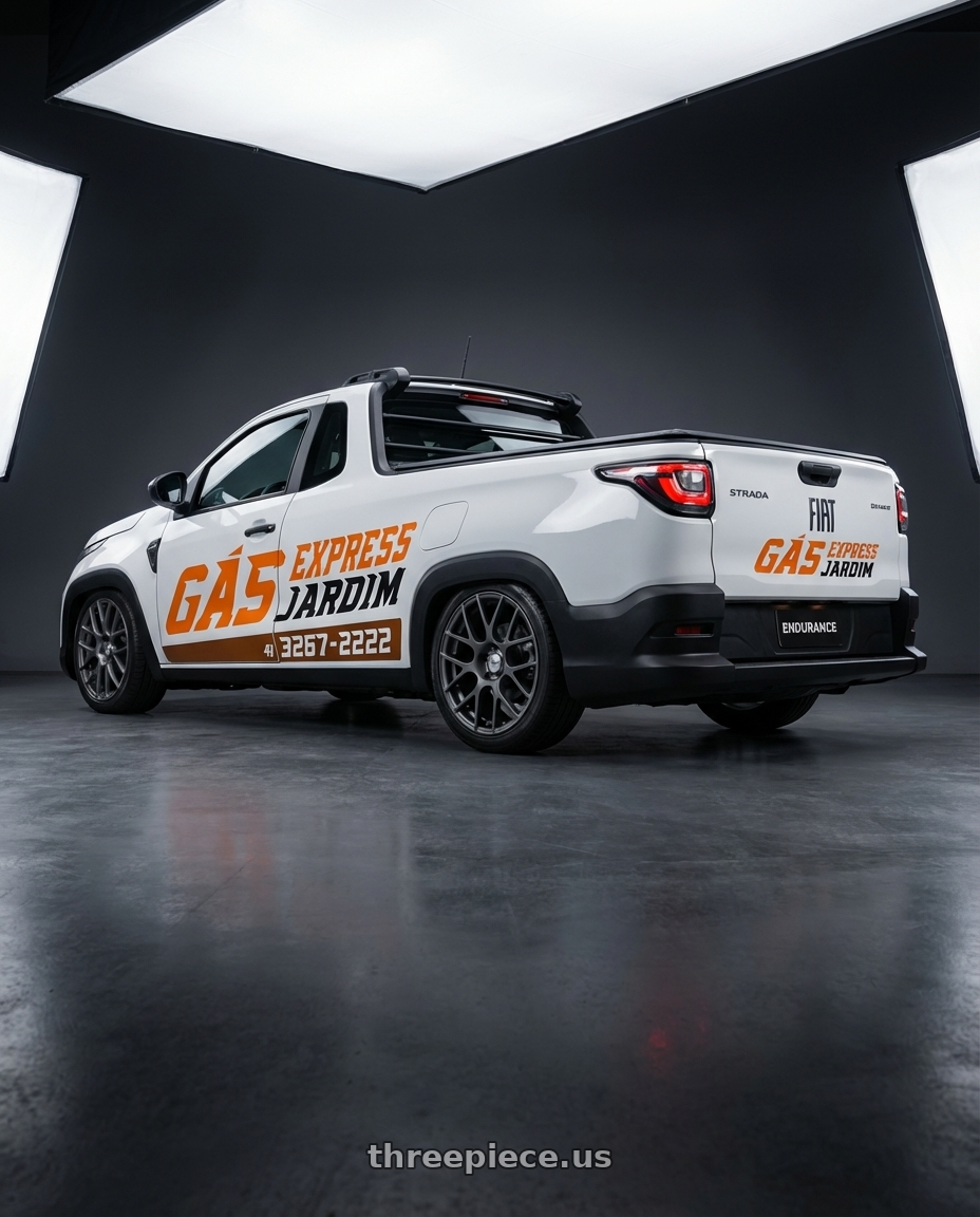 fiat strada endurance branca 2025  adesivada e parachoques preto with TSW NURBURGRING 5X114.3 17X7.5 +45 MATTE GUNMETAL wheels rear three quarter view square tires