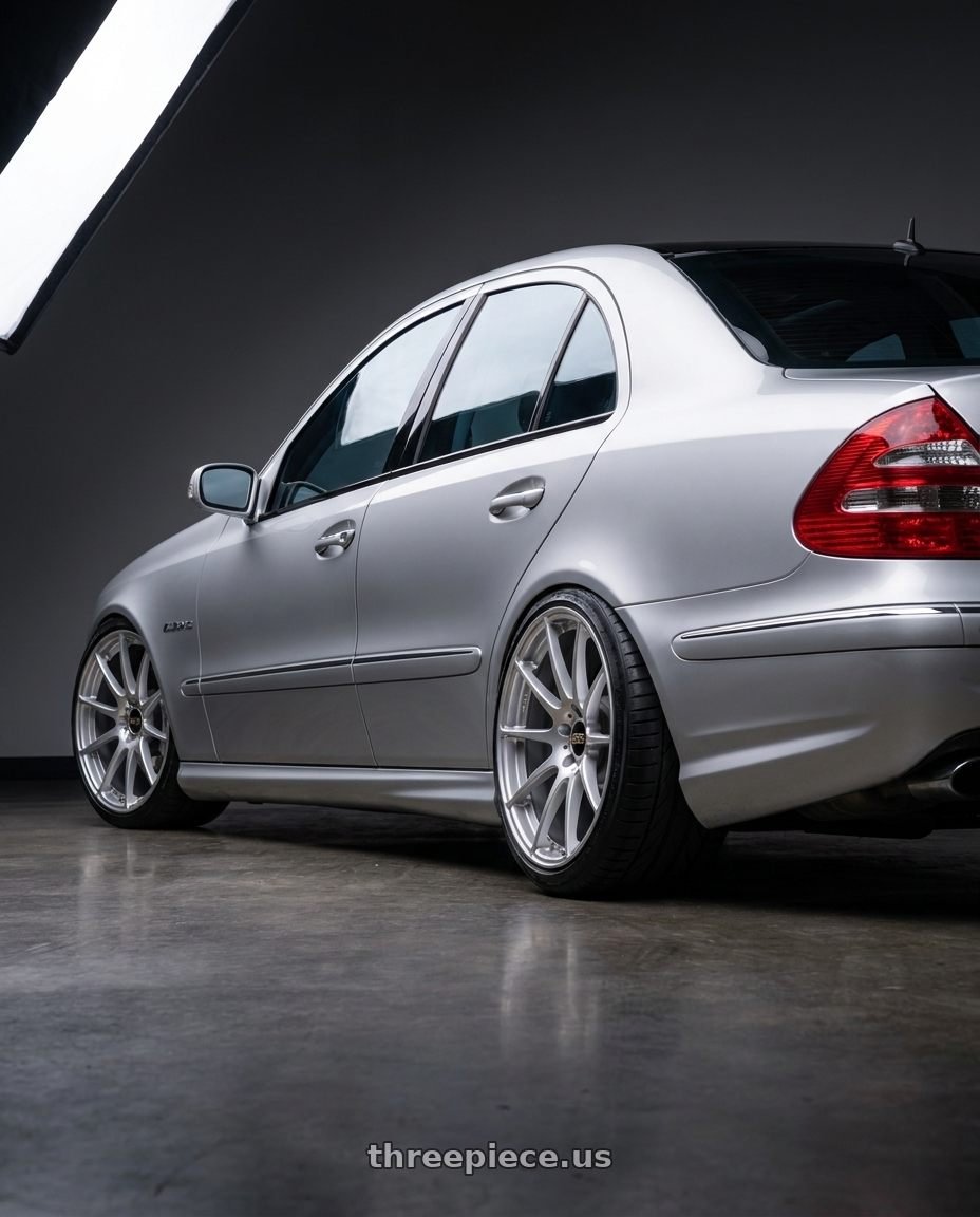 2006 Mercedes E55 AMG with BBS FS 5x112 19x10 +38 PFS Diamond Silver wheels rear three quarter view extreme stretch tires