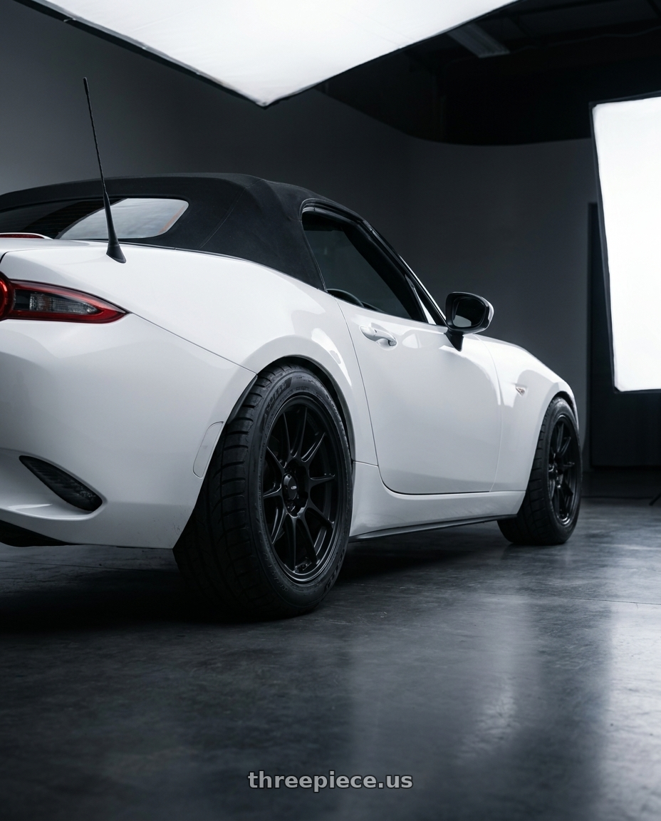 2024 nd mx5 soft top with Konig Dekagram 4x100 15x7.5+35 Semi-Matte Black wheels rear three quarter view meaty tires