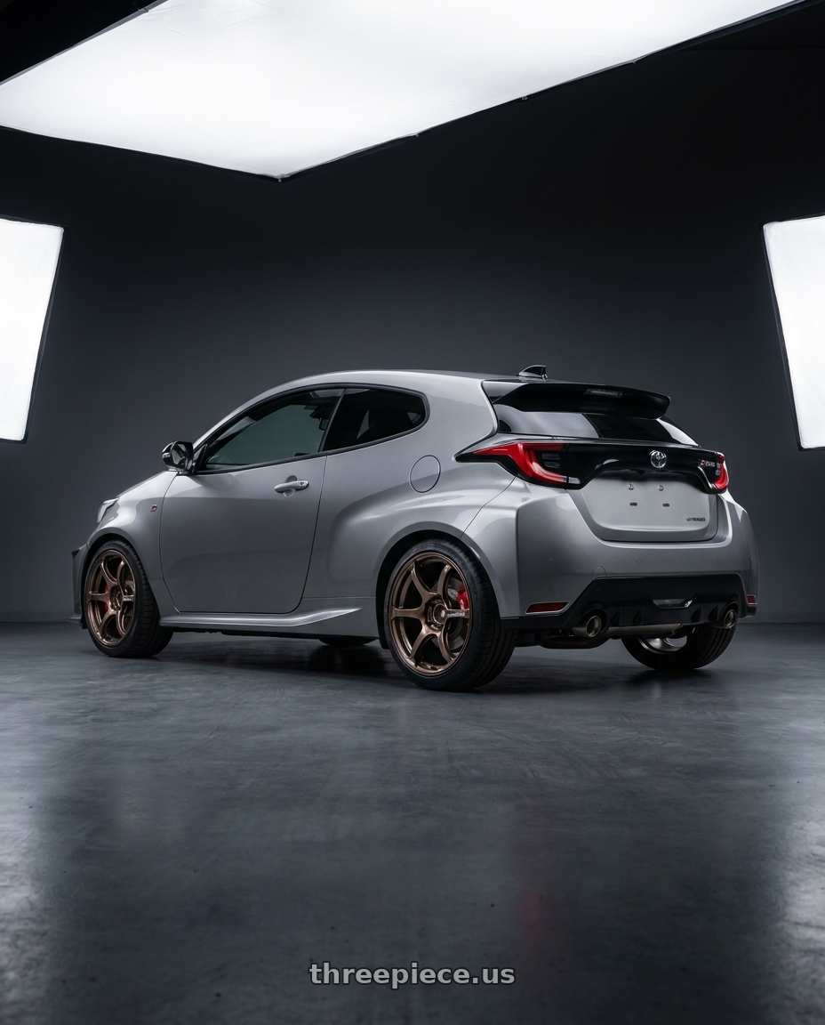 2025 toyota GR yaris Grey with Advan Racing RG-4 5x114.3 18x8.5 +37 RACING COPPER BRONZE wheels rear three quarter view square tires