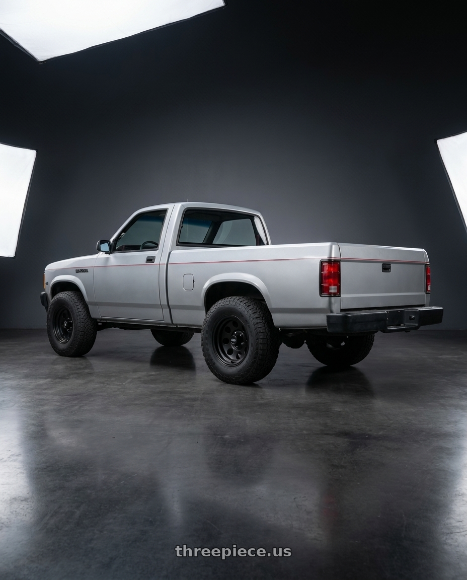 1990 dodge Dakota with American Racing AR172 BAJA 5X114.3 15X7 -6 SATIN BLACK wheels rear three quarter view meaty tires