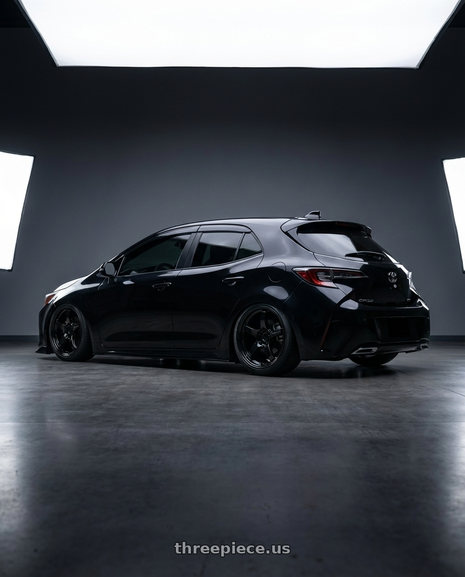 2022 Toyota corolla with Gram Lights 57CR 5x100 18x9.5 +38 GLASS BLACK wheels rear three quarter view slight stretch tires