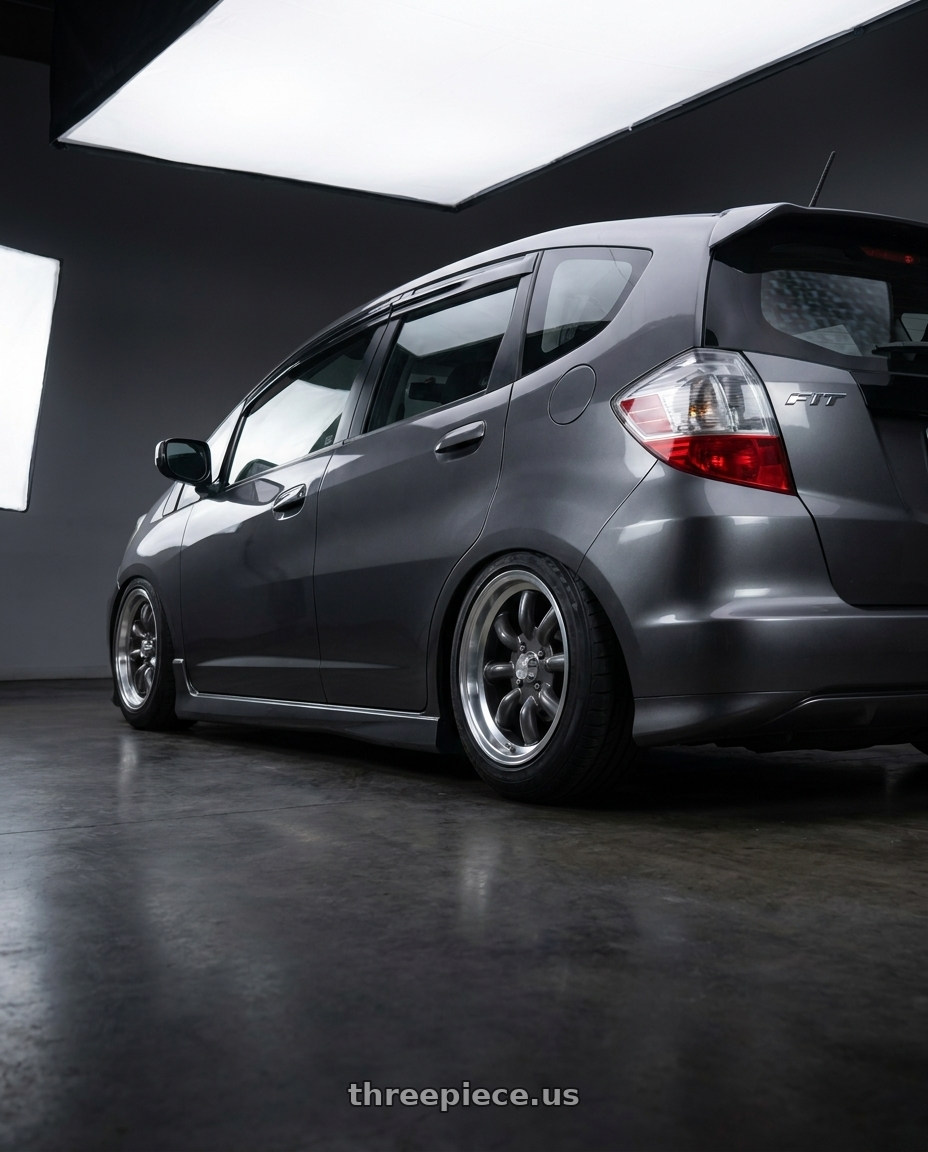 2013 honda fit with Konig Rewind 4x100 15x7+40 Graphite wheels rear three quarter view meaty tires