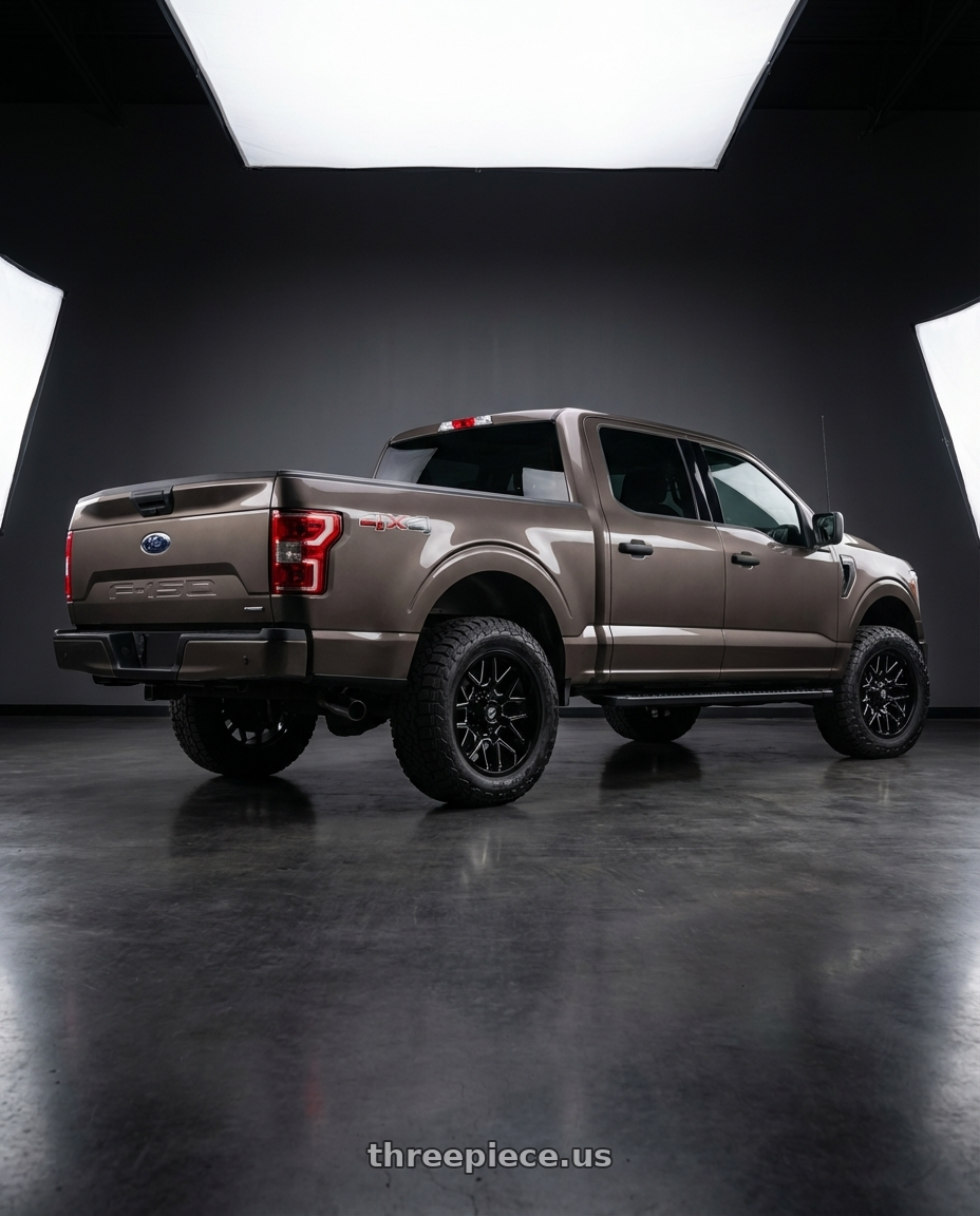2019 Ford F-150 with Gear Off Road 768BM 6X135/6x139.7 20x9 +0 Gloss Black Milled wheels rear three quarter view meaty tires