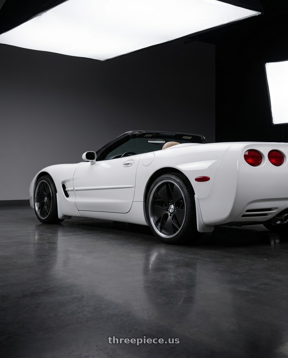 White 2004 corvette base convertible with Work Gnosis Cvd 5x120.65 19x10.5+45 O Disk Matte Black wheels rear three quarter view square tires