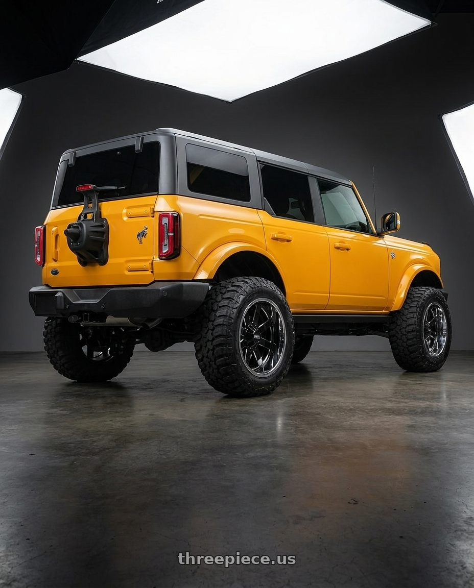 2024 Ford Bronco with Moto Metal MO200 6X139.7 20X12 -44 GLOSS BLACK MILLED CENTER CHROME LIP wheels rear three quarter view meaty tires