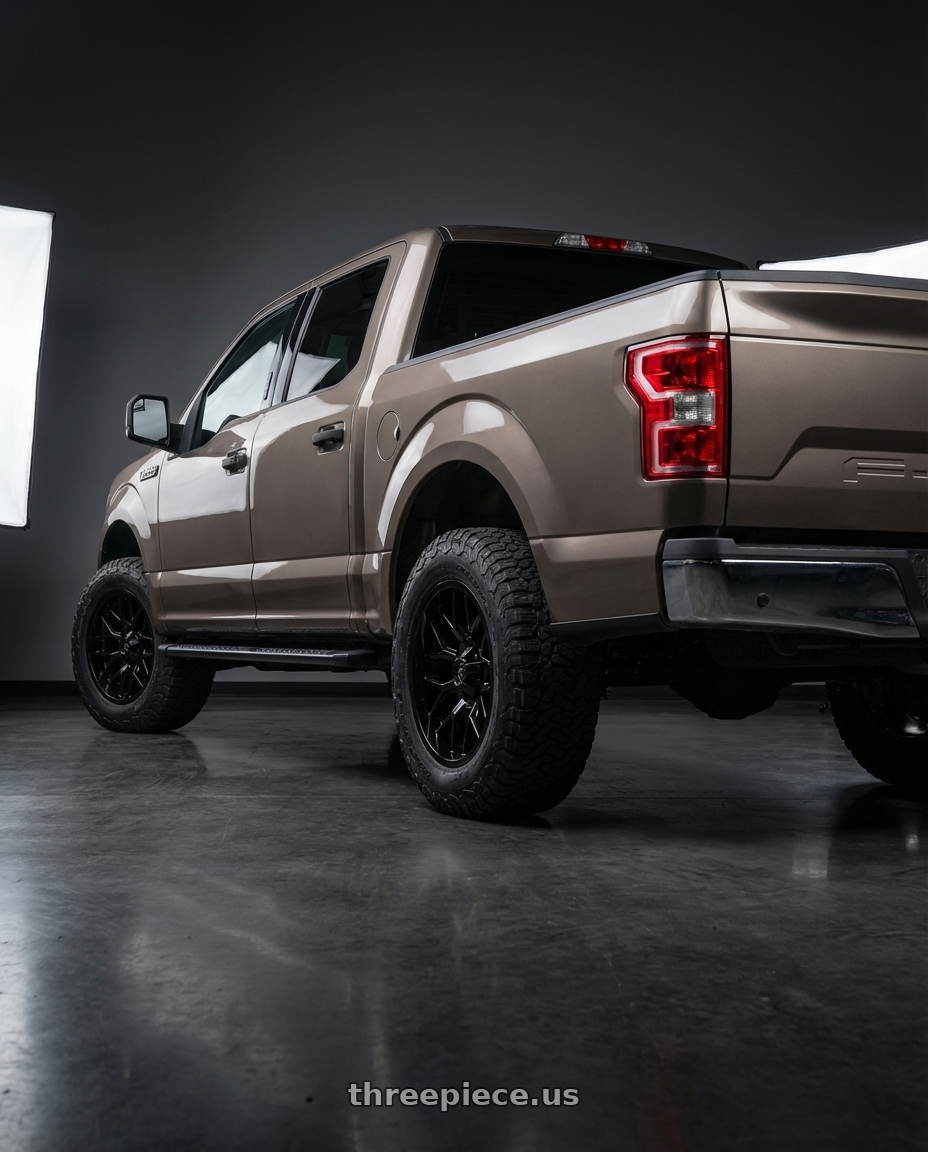 2019 Ford F-150 with Gear Off Road 768B 6X135/6x139.7 20x9 +18 Gloss Black wheels rear three quarter view meaty tires