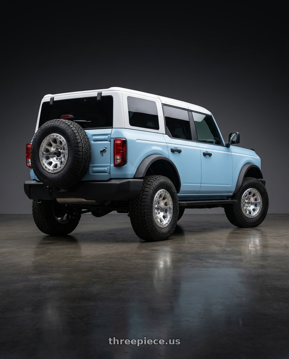 2025 Ford Bronco Heritage with KMC E25 BEADLOCK 6x139.7 17x9 -12 Machined wheels rear three quarter view square tires