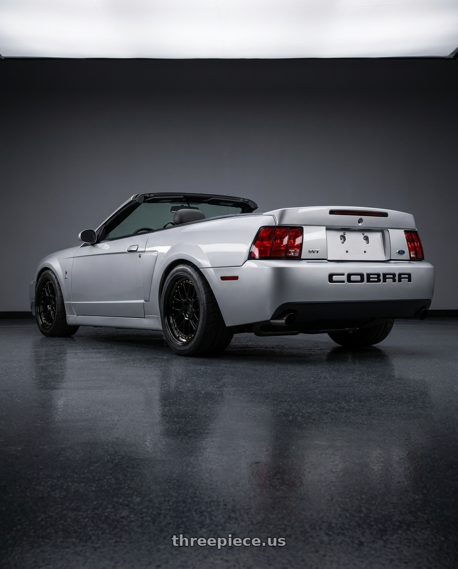 2004 ford mustang Svt cobra  with Aodhan DS06 5x114.3 18x9.5+22 Gloss Black W /Gold Rivets wheels rear three quarter view meaty tires