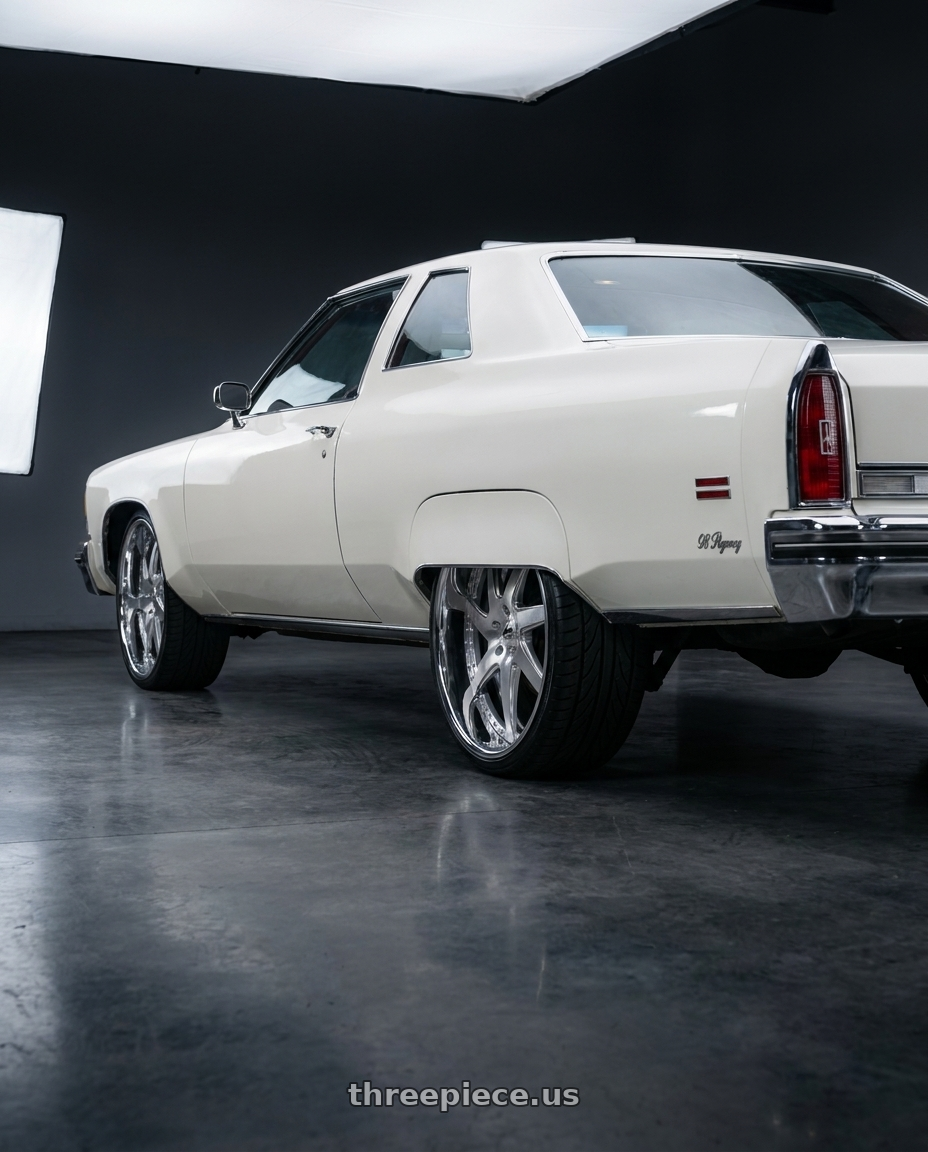 1976 Oldsmobile 98 Regency  with Amani Devine 5X127 26x10 +5 Brush center Chrome lip wheels rear three quarter view extreme stretch tires