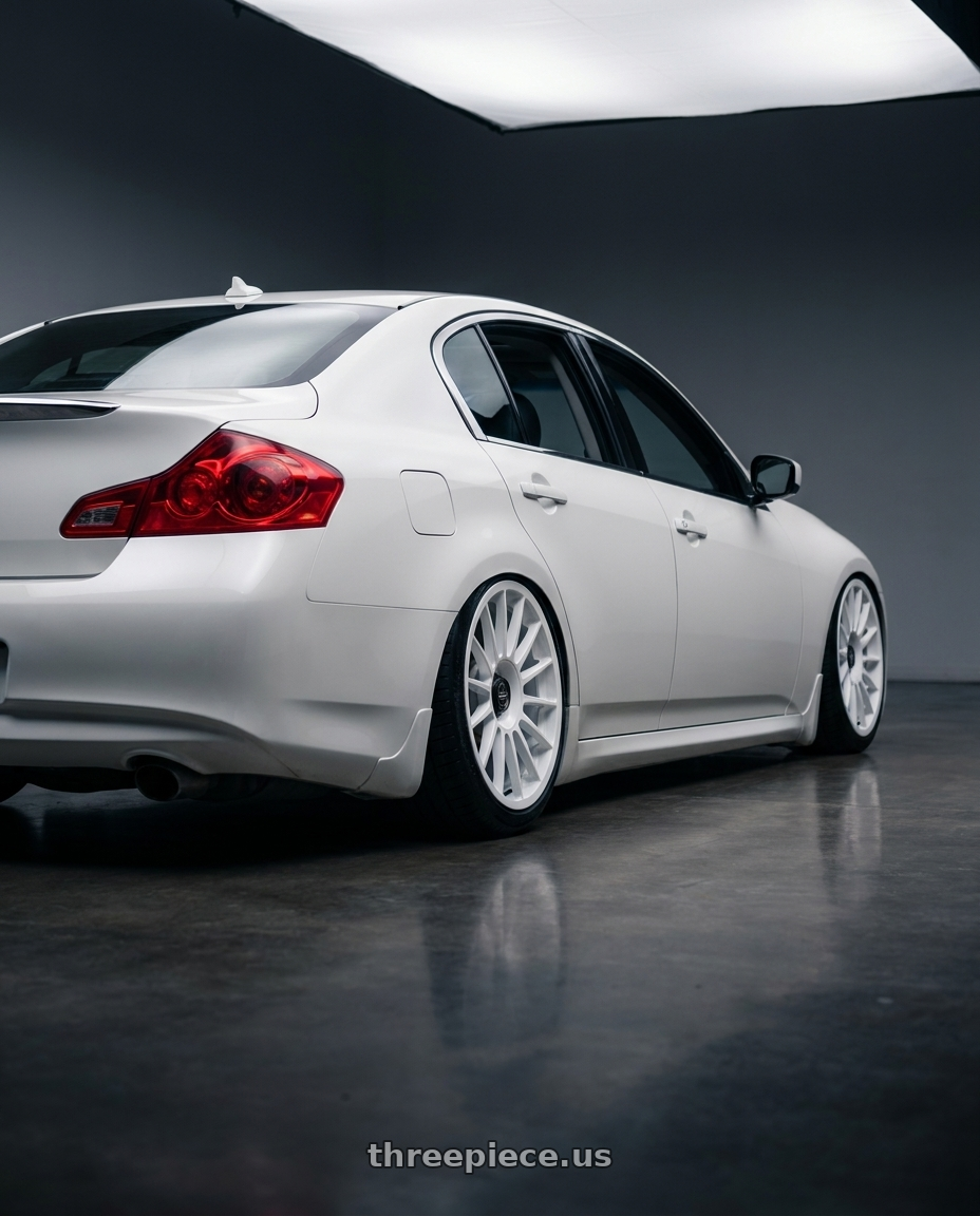 2012 Infiniti G37 with fifteen52 PODIUM 5x114.3 / 5x120 19x8.5 +35 RALLY WHITE (GLOSS WHITE) wheels rear three quarter view slight stretch tires