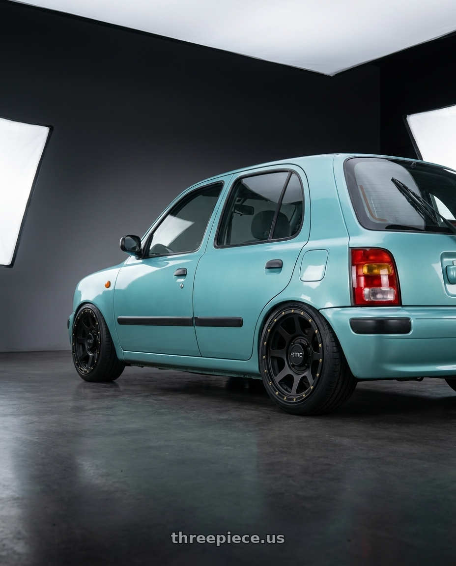 1996 NISSAN MARCH Tiffany Blue with KMC Powersports KS134 ADDICT 2 4X156 14X7 +10 SATIN BLACK wheels rear three quarter view square tires