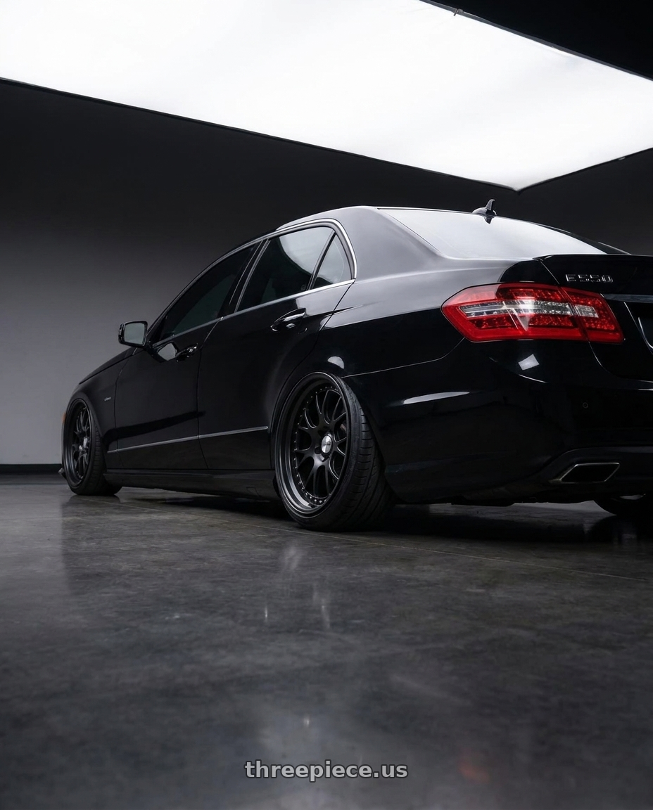 2010 Benz E550 with SSR Professor MS3 4x100 18x7+6 HP Disk Flat Black wheels rear three quarter view extreme stretch tires