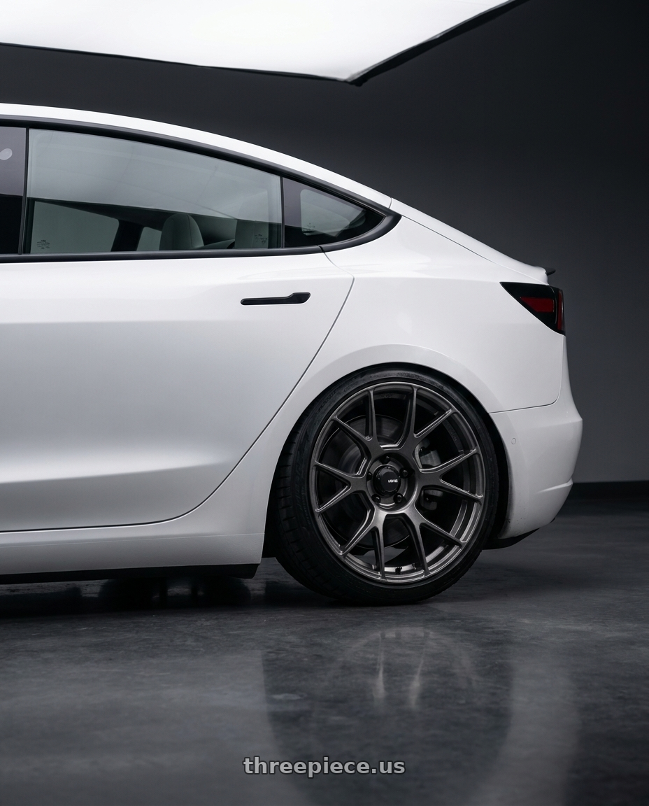 2023 Tesla Model 3 with Konig Ampliform 5x114.3 19x10.5+23 Dark Metallic Graphite wheels rear three quarter view slight stretch tires