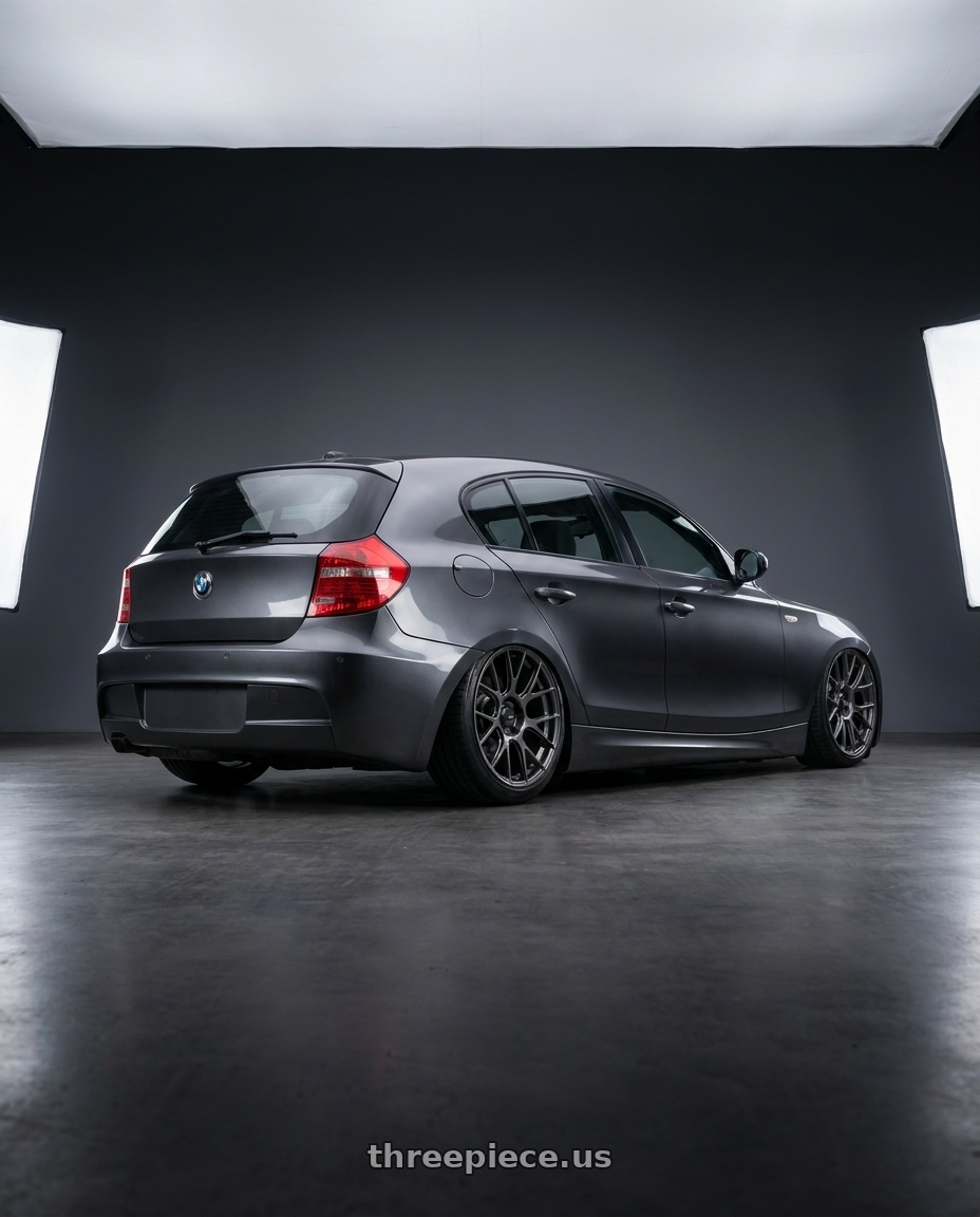 2012 BMW 1 Series E82 with Konig Ampliform 5x120 19x8.5+32 Dark Metallic Graphite wheels rear three quarter view slight stretch tires