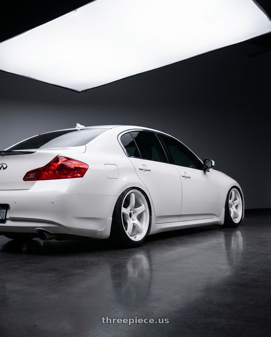 2012 Infiniti G37 with Gram Lights 57CR 5x114.3 19x9.5+45 Ceramic Pearl wheels rear three quarter view slight stretch tires