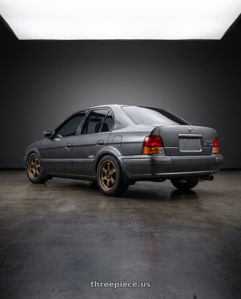 1996 Toyota Tercel EL51 with Konig Hypergram 4x100 15x8+35 Race Bronze wheels rear three quarter view square tires