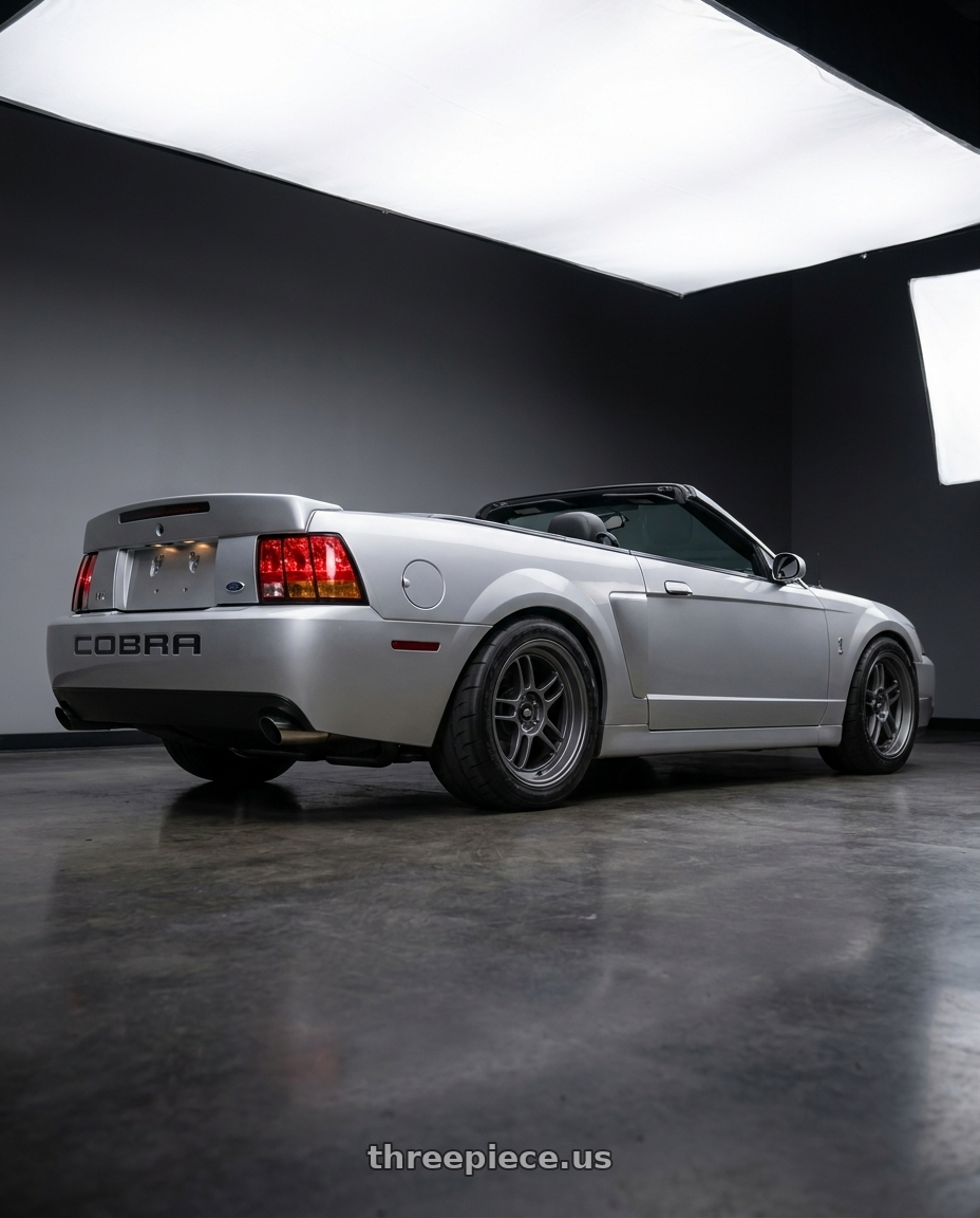 2004 Ford mustang with MST Wheels Suzuka 5X114.3 18x9.5 +25 Matte Gunmetal wheels rear three quarter view meaty tires