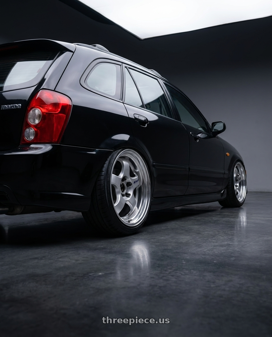2002 Mazda Protege5 with Work Meister S1 2P 5x114.3 15x6.5+38 A Disk Silver wheels rear three quarter view slight stretch tires