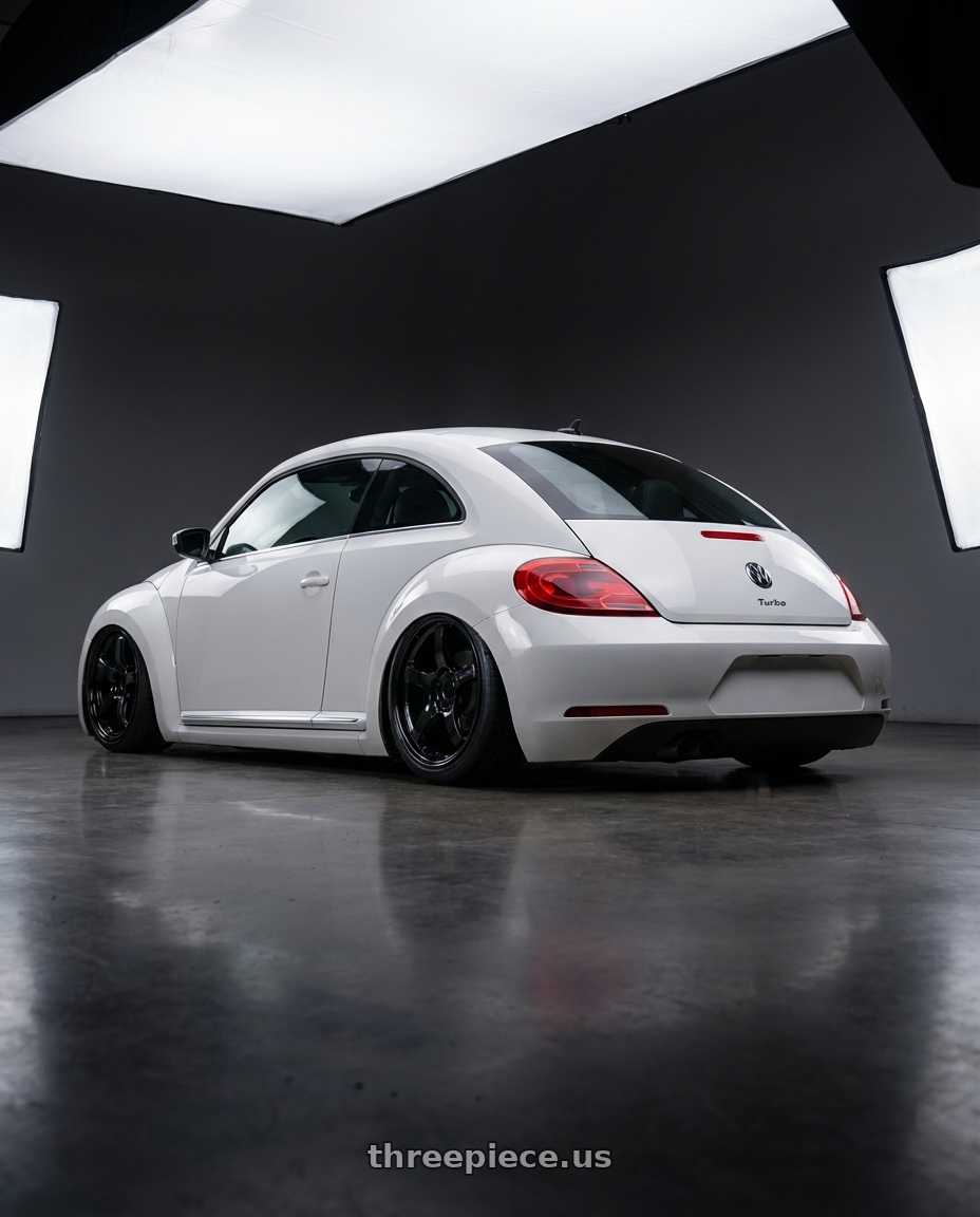 2016 Volkswagen Beetle Turbo with Gram Lights 57CR 5x112 19x8.5+45 Glossy Black wheels rear three quarter view slight stretch tires