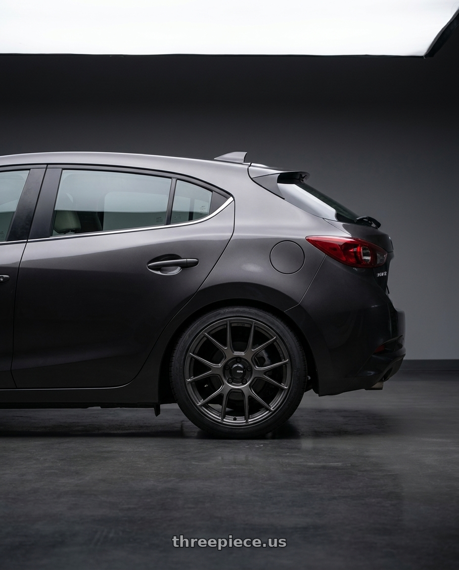 2017 Mazda Mazda3 Grand Touring with Konig Ampliform 5x114.3 18x8.5+35 Dark Metallic Graphite wheels rear three quarter view square tires