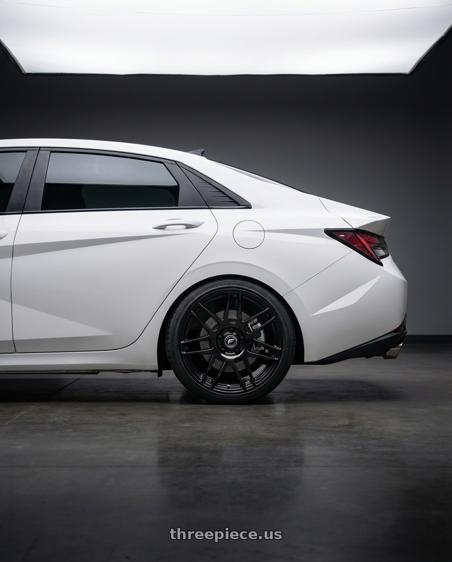 2024 Hyundai Elantra N with Forgestar F14 5x114.3 19x11 +15 Gloss Black wheels rear three quarter view square tires