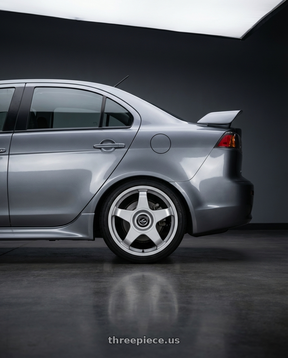 2014 Mitsubishi Lancer Ralliart with fifteen52 CHICANE 5x114.3 / 5x100 18x8.5 +35 SPEED SILVER (GLOSS SILVER) wheels rear three quarter view square tires