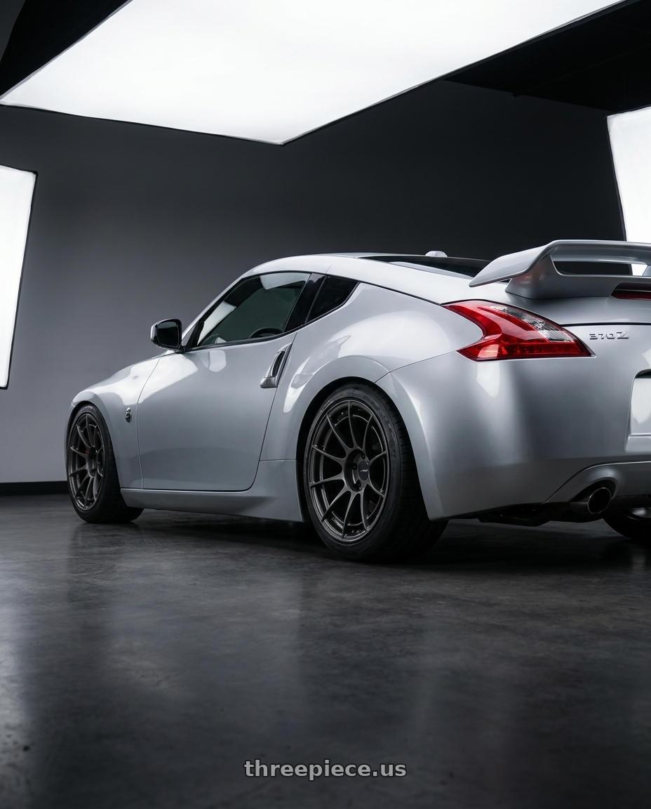 2014 Nissan 370z with Enkei NT03RR 5x114.3 18x9.5+27 Gunmetal wheels rear three quarter view square tires
