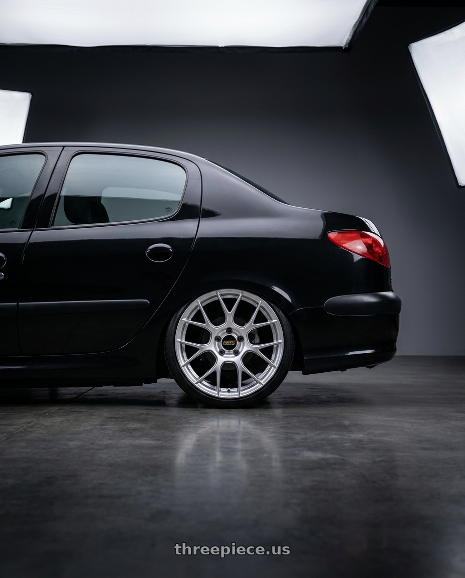 2011 Peugeot 206 SD with BBS RE-V7 5x112 18x8.5 +42 Diamond Silver wheels rear three quarter view square tires